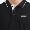 Man wearing navy collared t-shirt with short sleeves – close view