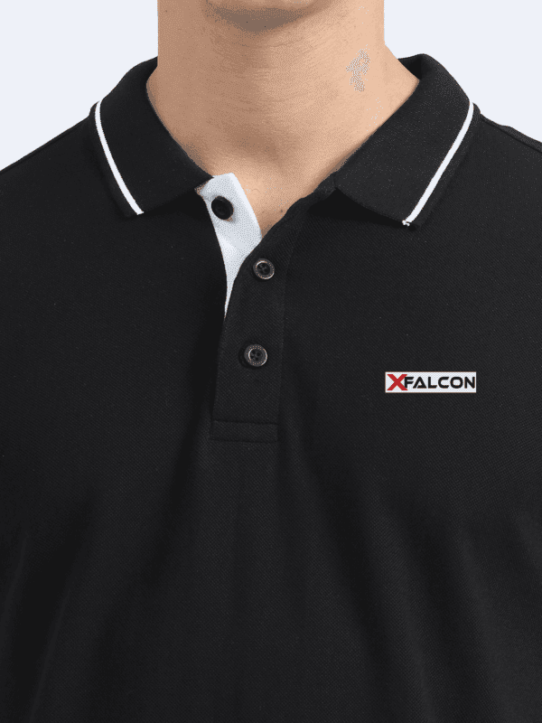Man wearing navy collared t-shirt with short sleeves – close view