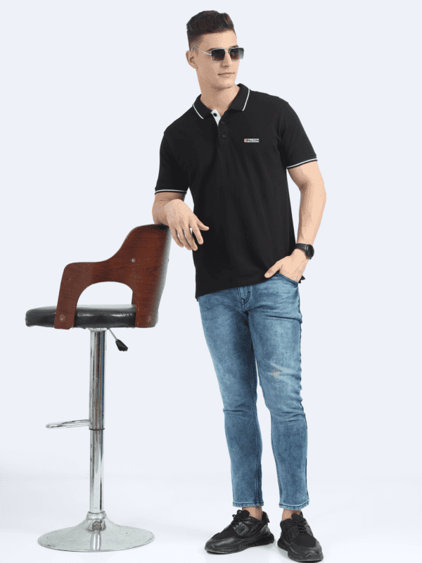 Standing view of a man wearing a navy blue polo t-shirt
