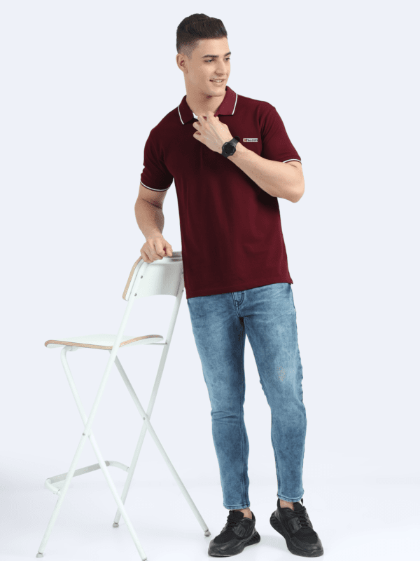 Man’s back in a maroon polo shirt with stylish white piping